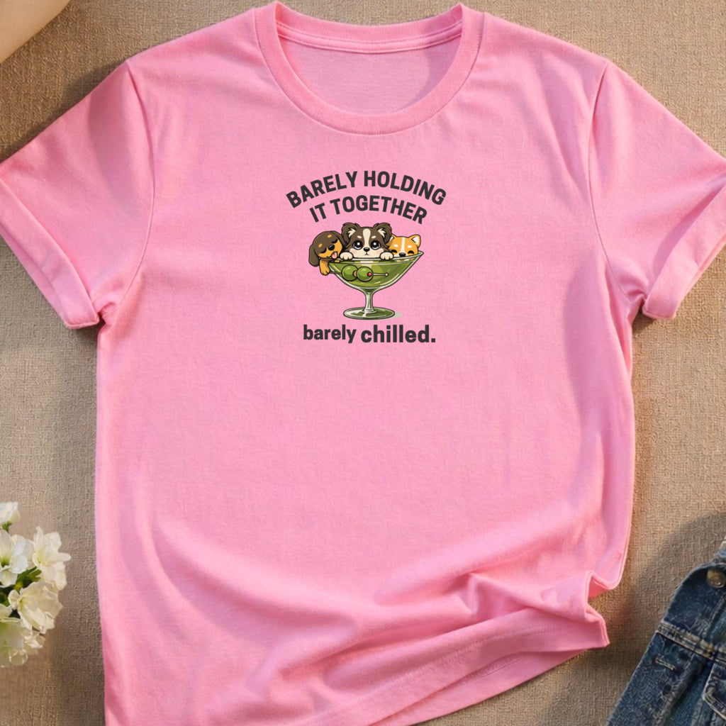 Pink t-shirt with "Barely Holding It Together" graphic of puppies and kittens in a martini glass.
