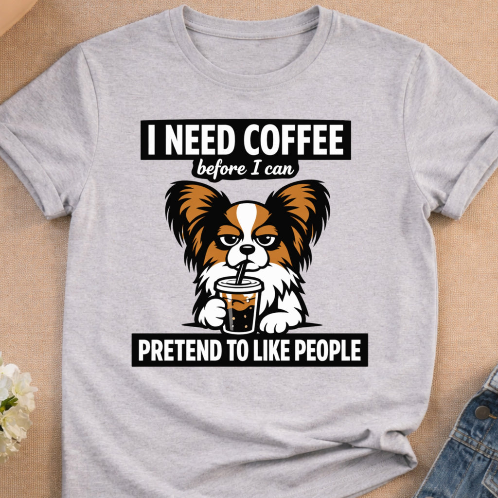 Dog in t-shirt with "I need coffee before I can pretend to like people" text.