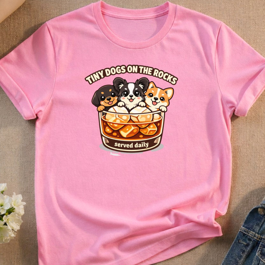 Pink t-shirt with cartoon dogs in a glass and text "Tiny Dogs on the Rocks served daily".
