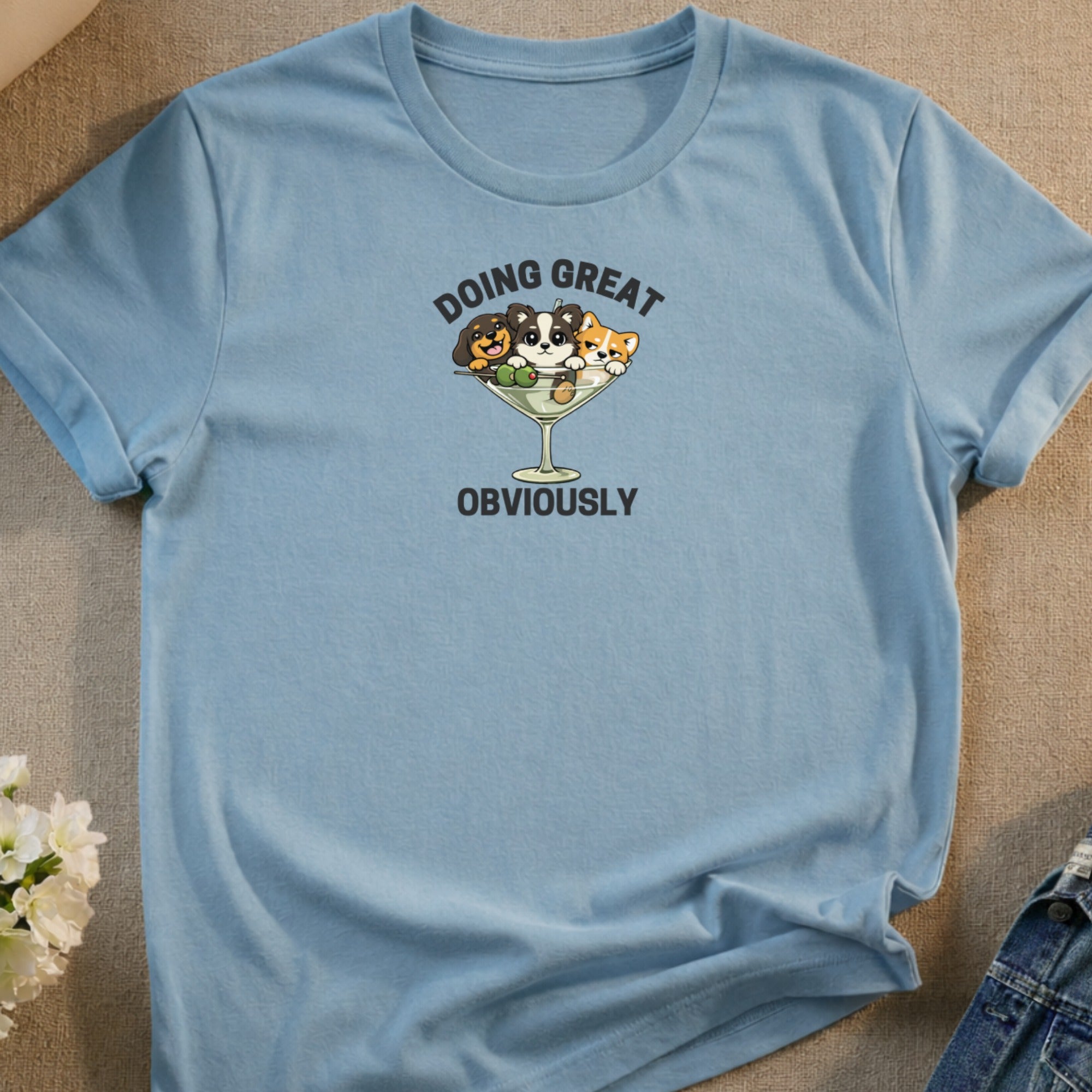 Light blue t-shirt with cartoon dogs in a martini glass that says "Doing Great, Obviously."