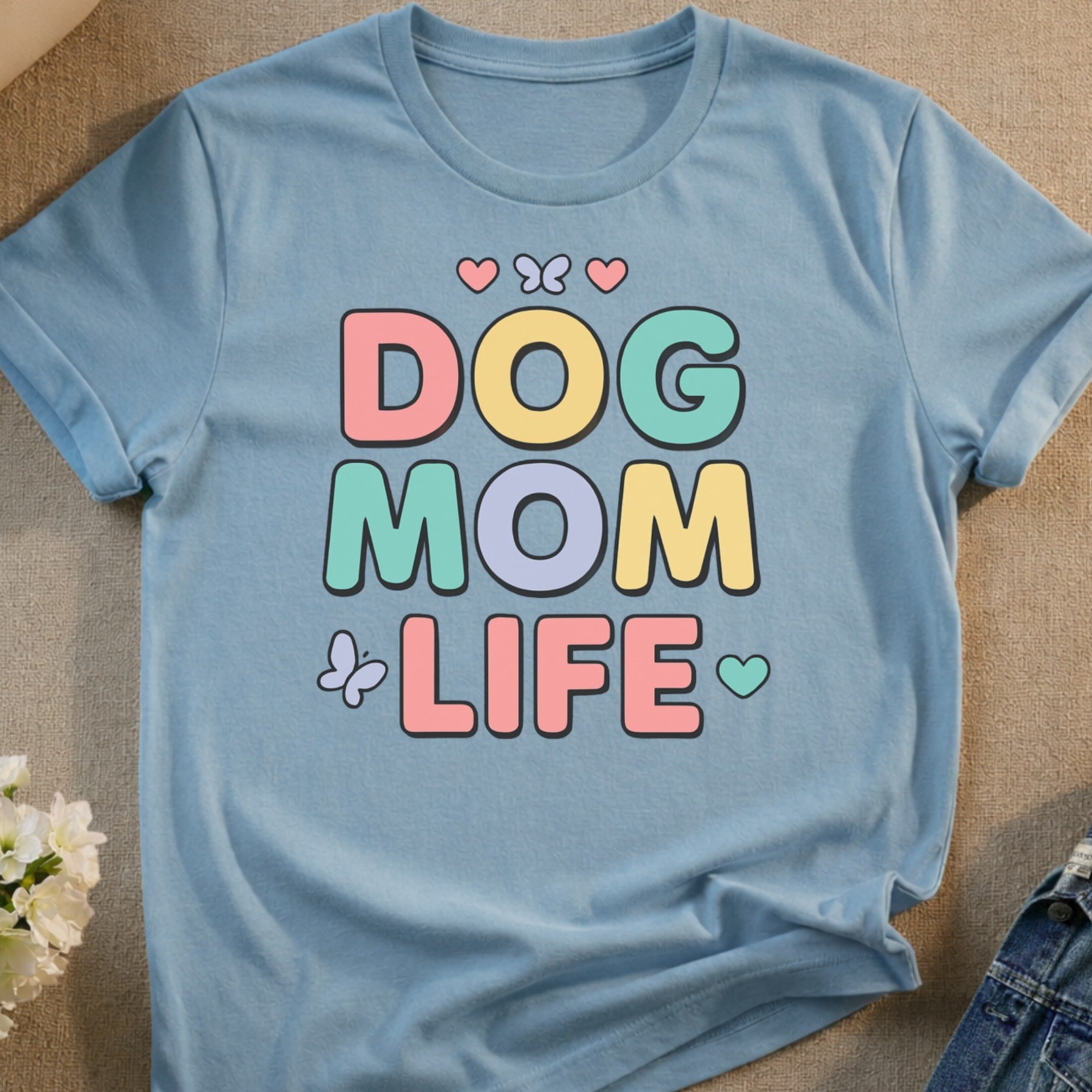 Light blue t-shirt with "DOG MOM LIFE" in colorful, block letters.