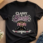 Black t-shirt featuring sparkly cowboy boots with pink leopard print bows.