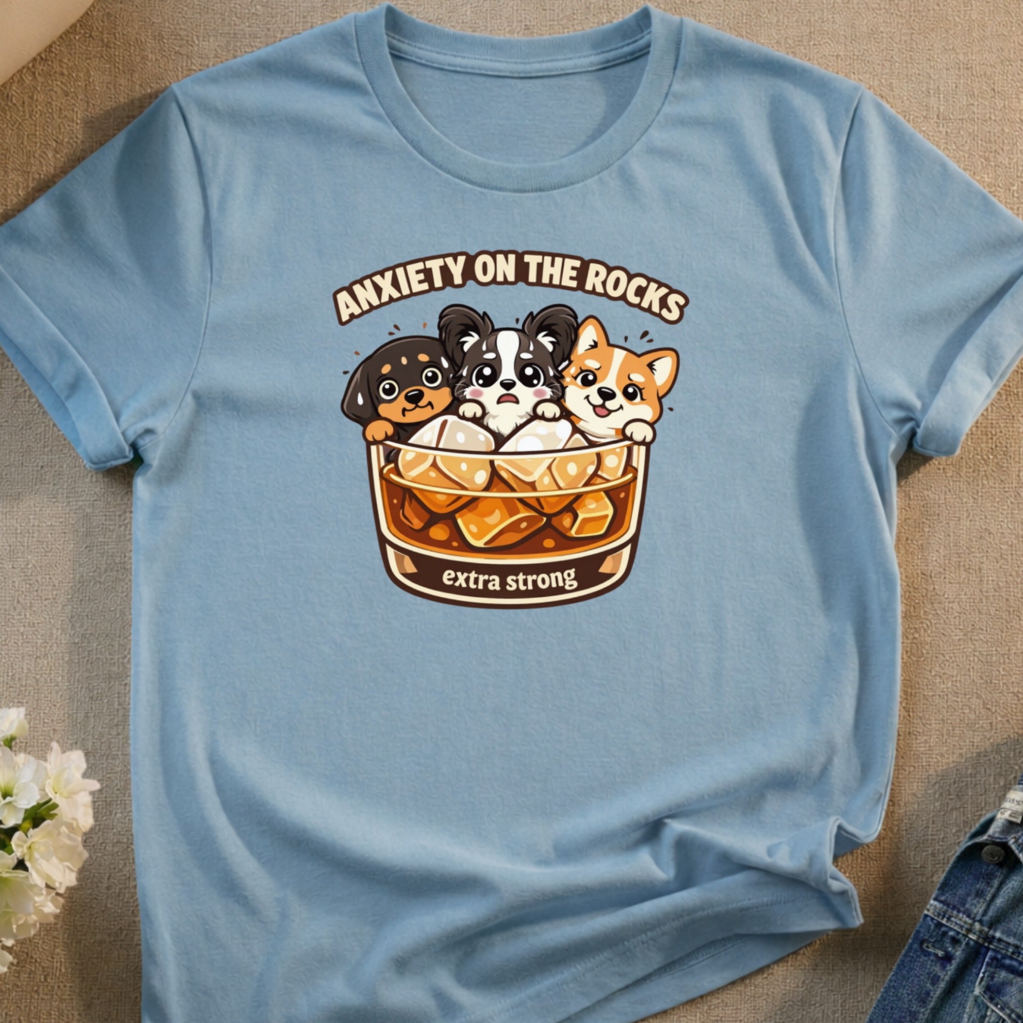 Light blue t-shirt with cartoon dogs in a glass labeled "Anxiety on the Rocks Extra Strong".