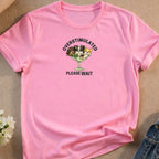 Pink t-shirt with "OVERSTIMULATED PLEASE WAIT" text and cartoon dogs in a martini glass.