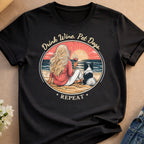 Woman with dog on beach, drinking wine, with text "Drink Wine. Pet Dogs. Repeat."
