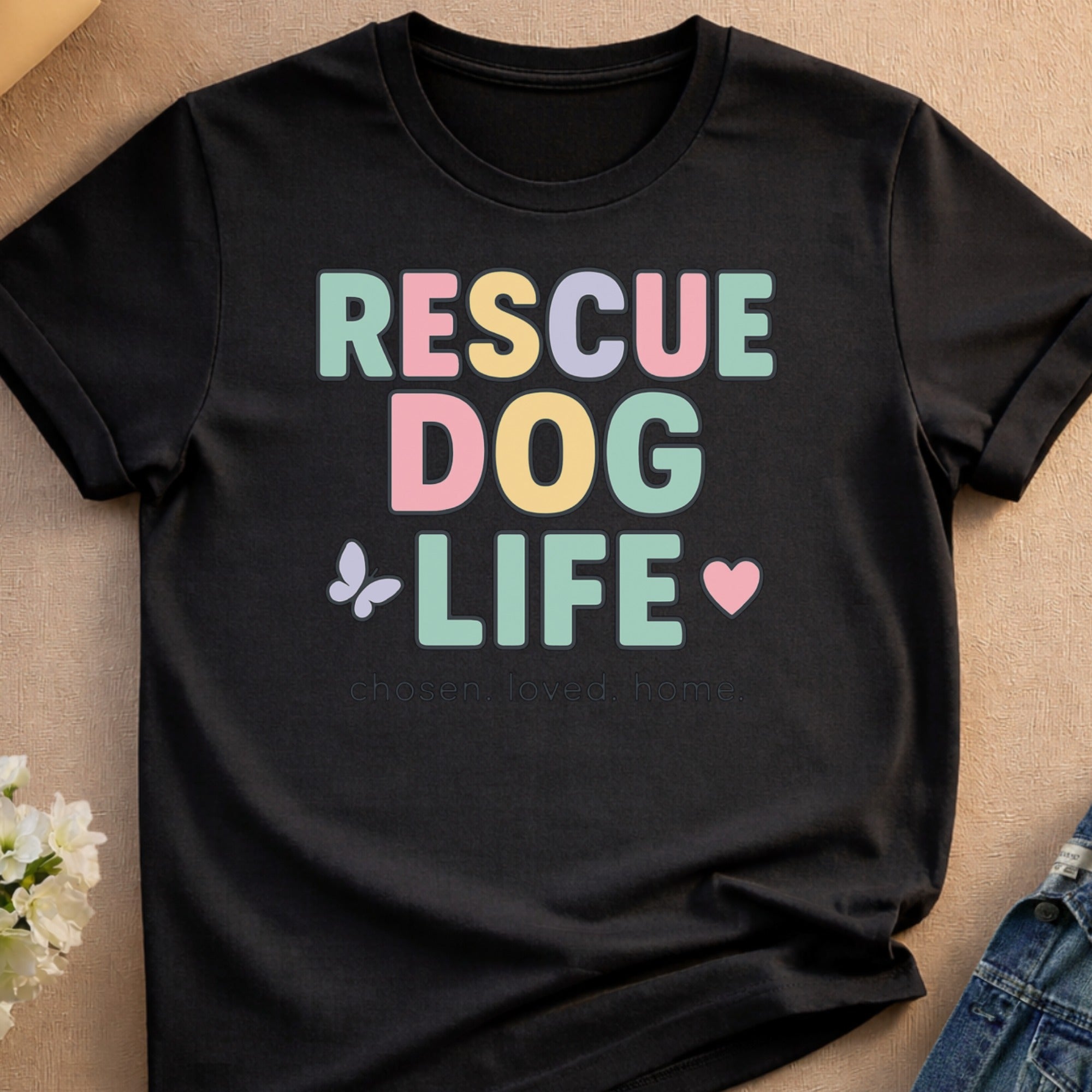 Black t-shirt with "RESCUE DOG LIFE" text and small heart and butterfly graphics.