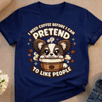 Navy t-shirt with cartoon dog in coffee cup saying "I need coffee before I can pretend to like people."