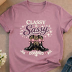 Classy Sassy cowboy boots with leopard print bows on a purple t-shirt.