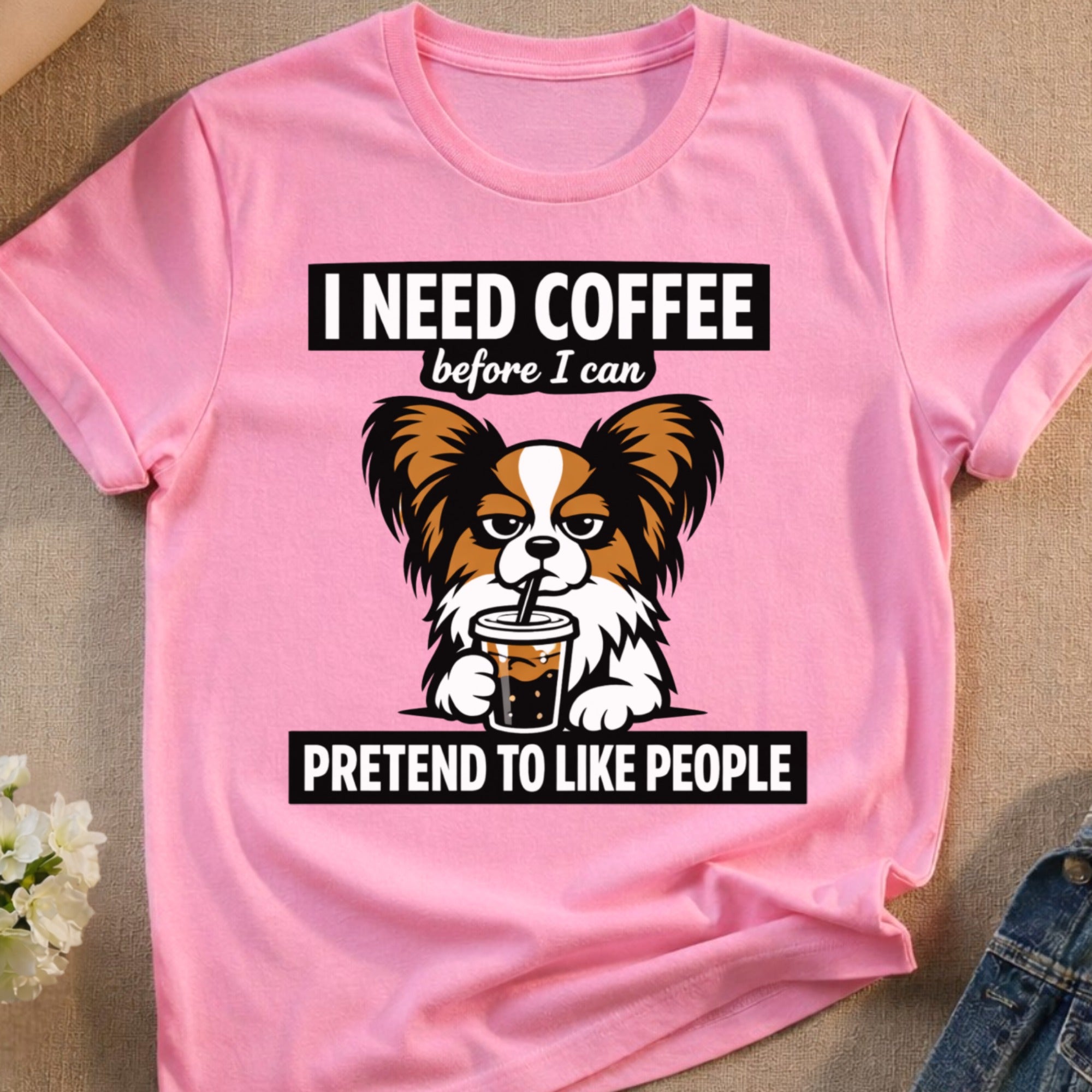 Pink t-shirt with text "I need coffee before I can pretend to like people" and dog.
