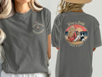 Woman in gray t-shirt, front: "Uncorked & Unleashed" graphic. Back: Beach scene with dog, "Wine a Little, Wag a Lot".